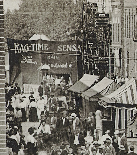 girls people woman usa signs man men history dogs boys kids buildings walking advertising children awning clothing women mail camden crowd indiana fair streetscene flags celebration shops pedestrians storefronts businesses carrollcounty realphoto hoosierrecollections