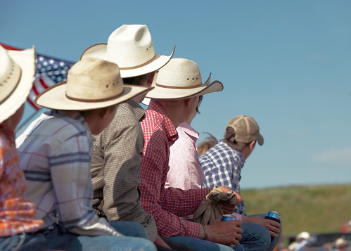 summer people color male men boys beer wearing horizontal cowboys rural fence season fun outdoors montana day mt looking action flag cleveland country watching young sunny americanflag bluesky fair depthoffield riding busy shirts american western fourthofjuly rodeo recreation fans copyspace activity spectators chinook summerfun sideview groupofpeople wildwest attentive alert clearsky lookingaway cowboyhats ranching traditionalculture caucasian westernwear fascinated drinkingbeer attentiongrabbing inthestands blainecounty sittingonfence ridingthefence westernapparel montanaphotographer toddklassyphotography