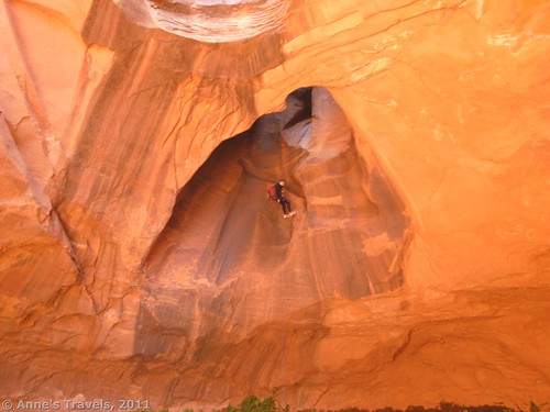 Repelling through the potholes of the Golden Cathedral in Glen Canyon National Recreation Area, Utah
