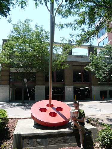 Mr. Schu reads at a giant button and needle in Kansas City