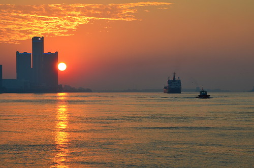 red orange sun clouds sunrise amber gm detroit headquarters center renaissance freighter