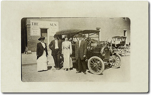 people woman usa signs man men history cars industry sepia buildings advertising clothing women shoes hats indiana parade rochester machinery transportation pedestrians buggy buggies automobiles businesses fultoncounty realphoto hoosierrecollections