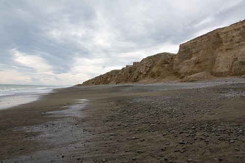 beach canterbury cliffs clouds coast grey newzealand ocean sand sea stones wakanui