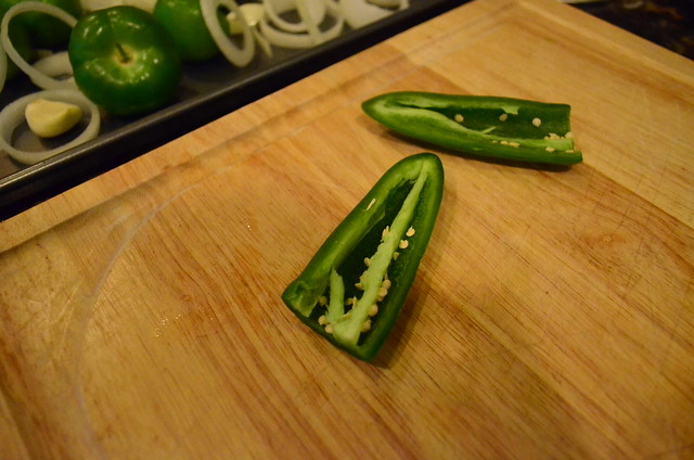 A jalapeno sliced in half showing the seeds that are inside.