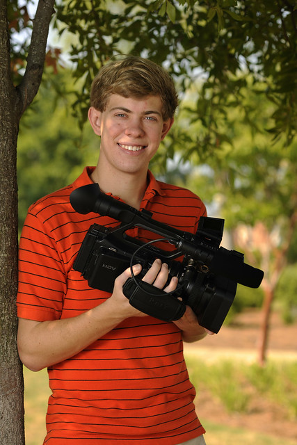 Brock Hansen poses with a video camera.