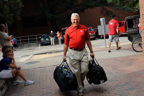 Chancellor Woodson carries some luggage to help students move in on Saturday.