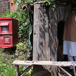 Mail box or postbox and barber at work near Rawalakot, Kashmir