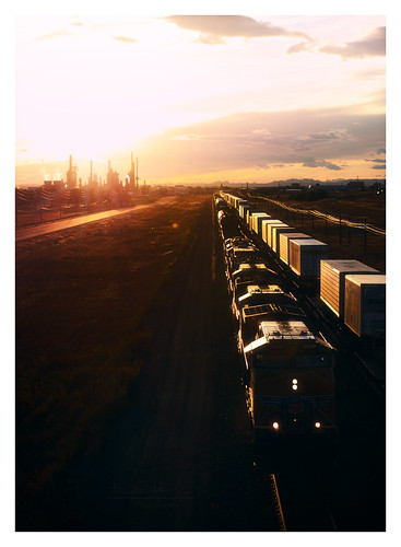 sunset sky usa sun silhouette america train golden us bright tracks engine transportation western locomotive wyoming prairie setting refinery bnsf frontier cheyenne cheyene