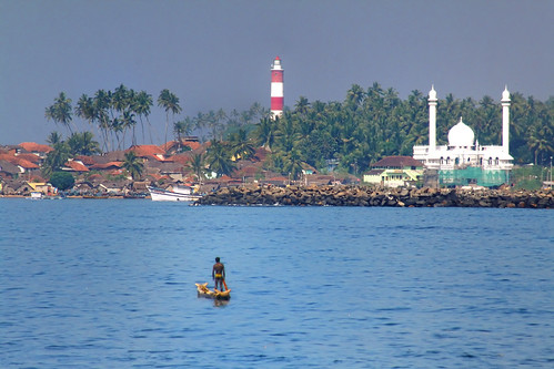ocean travel blue summer lighthouse india tourism beach water river palms island coast boat seaside fishing fisherman fishermen view coconut background indian south traditional working scenic floating tranquility fishnet landmark kerala tourist palm exotic coastal heat tropical rowboat coastline relaxation kollam backwaters waterscape quilon areyarey