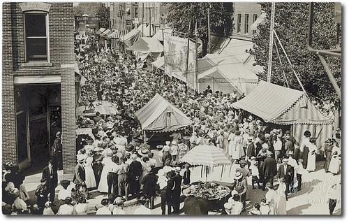 girls people woman usa signs man men history dogs boys kids buildings walking advertising children awning clothing women mail camden crowd indiana fair streetscene flags celebration shops pedestrians storefronts businesses carrollcounty realphoto hoosierrecollections