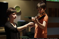 amy giving nick a violin lesson in our living room 