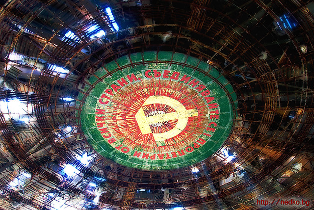A proletarian motto and soviet symbol under the roof of an old bulgarian communist monument at Buzludzha