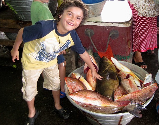 kid with fresh fish in el salvador la pier