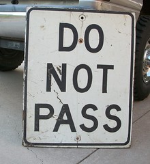 This white sign means don't pass:

Until after you pass the sign
Unless it seems safe to do so
Other vehicles for any reason

