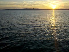 The sun sinks behind Staten Island