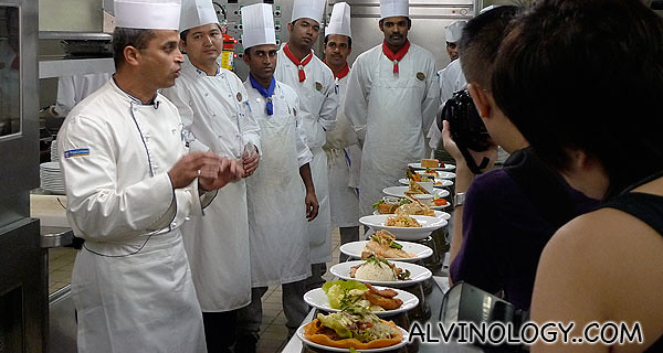 The colour of the neck handkerchief denotes the rank of the chef. The guy on the extreme left is the head honchu