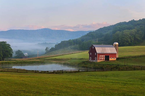 red mountains field clouds barn sunrise pond fences scene
